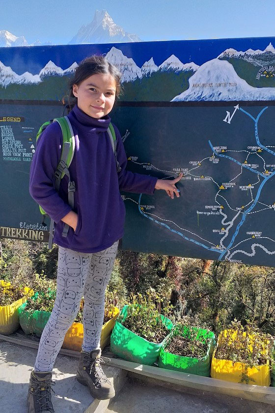 Tips for hiking with kids - child shows something on map 