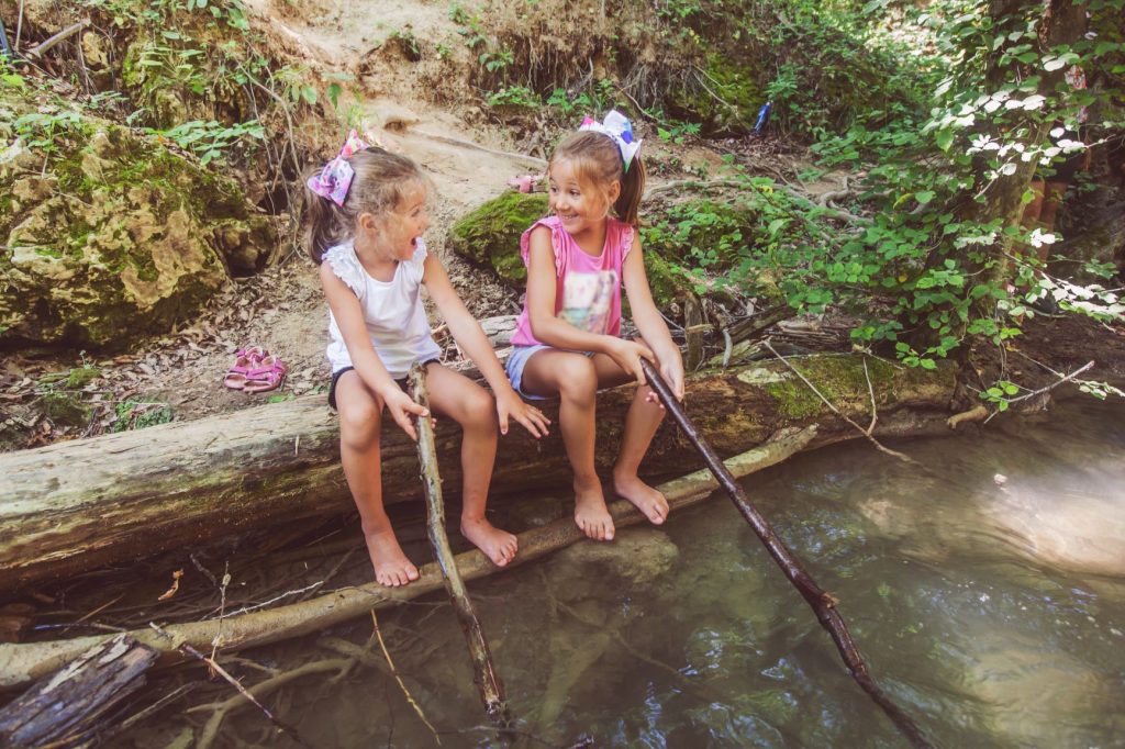 Kids playing in a creek in summer 